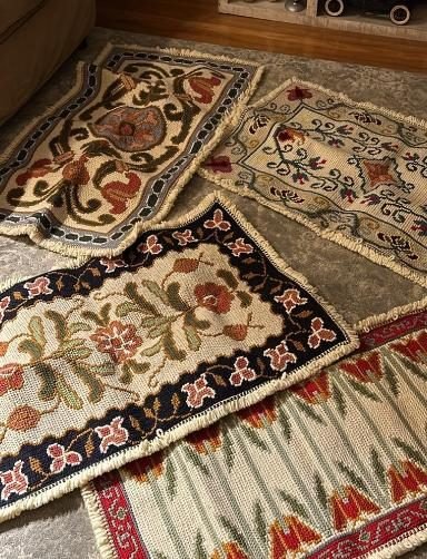 A stack of finished Arraiolos tapestries