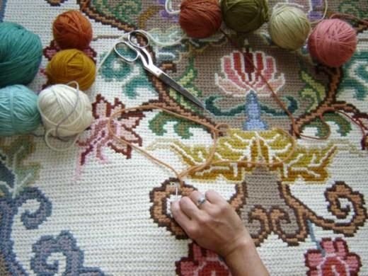 Colorful wool and a tapestry in progress